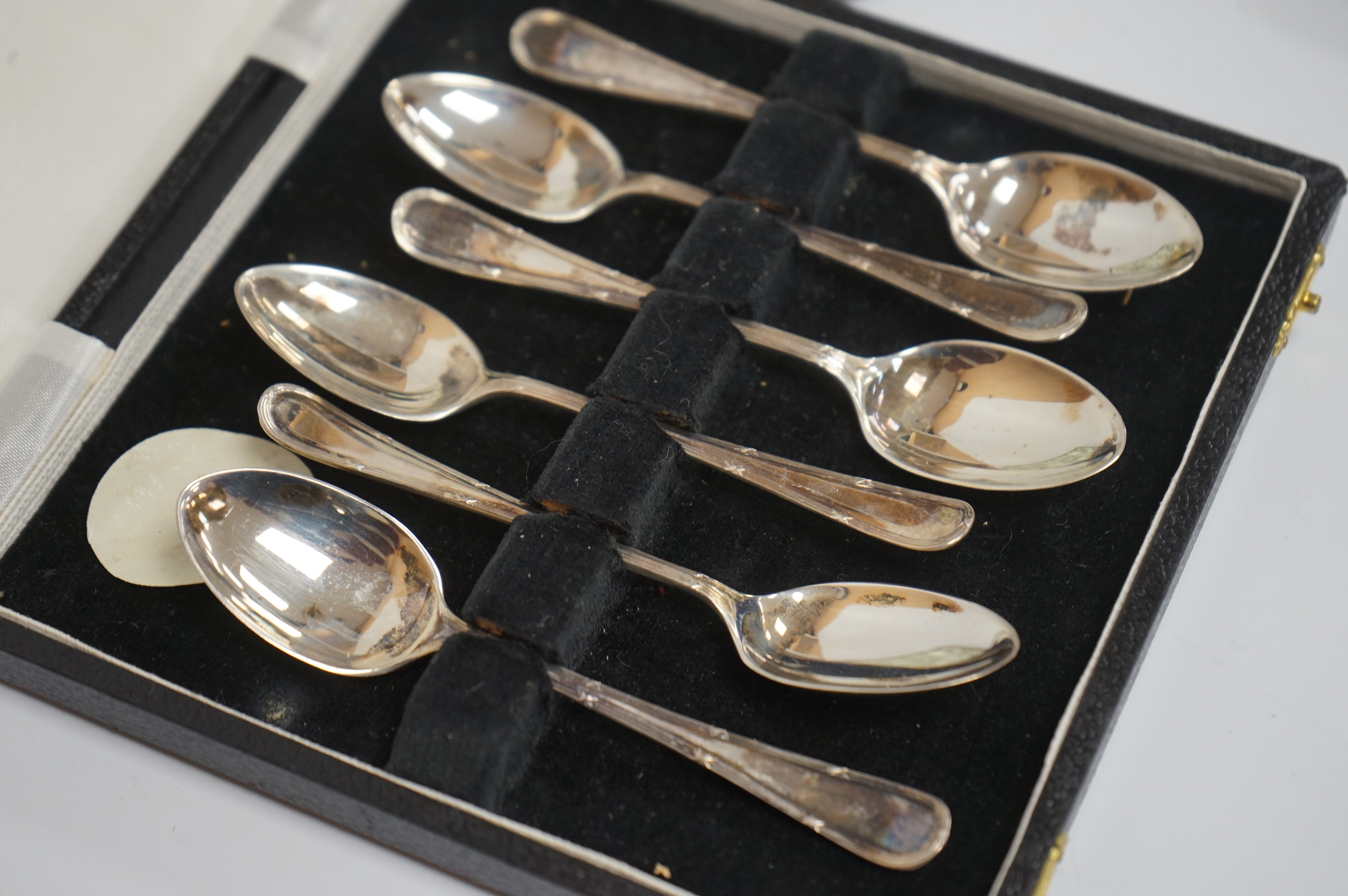 A cased pair of Victorian silver serving spoons and matching sifter spoon with engraved floral decoration, Atkin Brothers, Sheffield, 1888, together with a cased set of six late Victorian silver coffee spoons and matchin